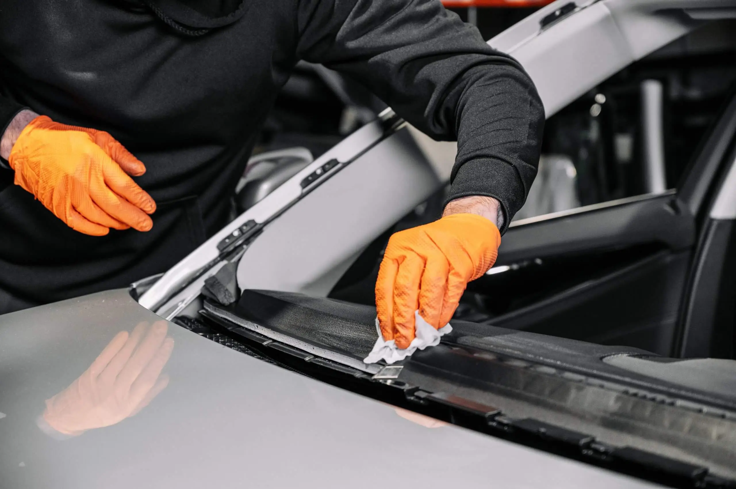 close-up-car-glazing-fixing-repairing-windshield-windscreen-replace-process-car-garage-service-cleaning-dashboard-Copy-scaled.jpg.webp